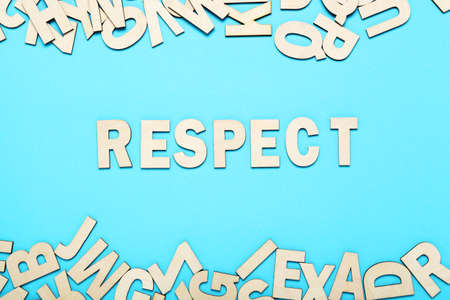 Word Respect by wooden letters on blue background