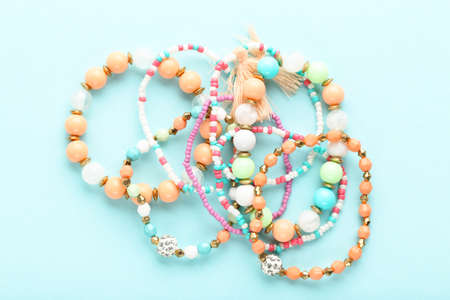 Beautiful bracelets on blue background