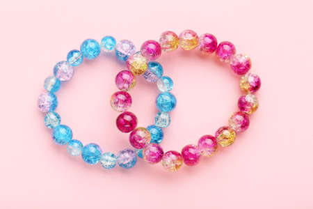 Beautiful bracelets on pink background