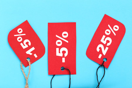Sale tags with percents on blue backgroundの写真素材