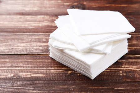 Paper napkins on brown wooden table
