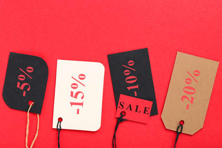 Colorful sale tags on red backgroundの写真素材
