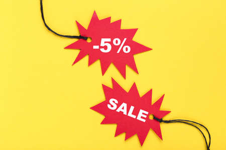 Sale tags with percents and word Sale on yellow backgroundの写真素材
