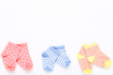 Baby socks on white wooden tableの写真素材