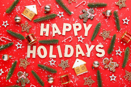 Christmas ornaments with text Happy Holidays on red background