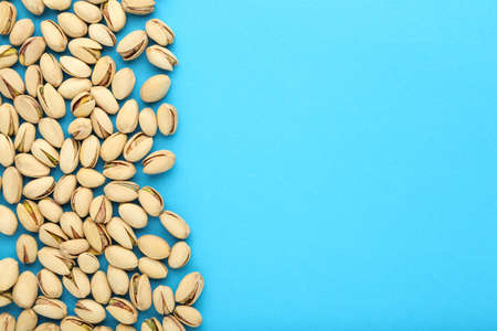 Tasty pistachios on blue backgroundの写真素材