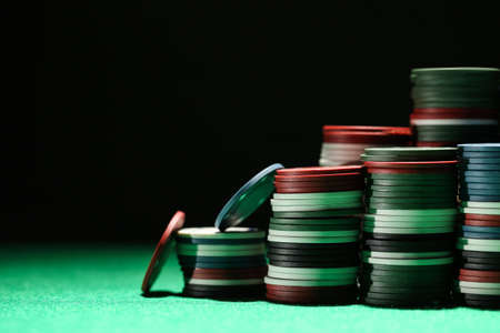 Stacks of poker chips on green tableの写真素材