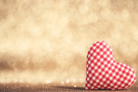 Valentine red fabric heart on blurred backgroundの写真素材