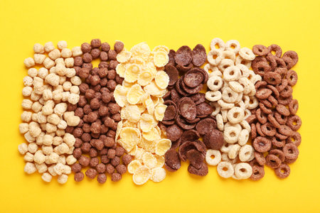Various corn flakes on yellow backgroundの写真素材