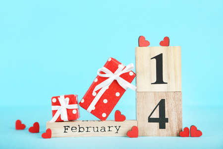 February block calendar with red hearts and gift box on blue background