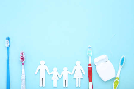 Family figures with toothbrushes on blue backgroundの写真素材