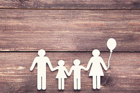 Family figures on brown wooden tableの写真素材