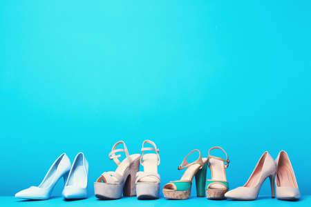 Different female shoes on blue background