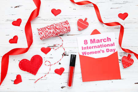 Card with text 8 March International Womens Day in envelope. Ribbon with rope, hearts, clothespins...