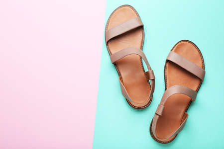 Female beige sandals on colorful backgroundの写真素材