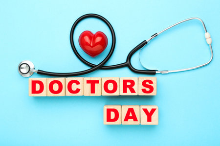 Stethoscope with red heart and text Doctor's Day on blue backgroundの写真素材