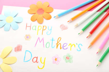 Text Happy Mother's Day with colorful pencils and paper flowers on pink backgroundの写真素材
