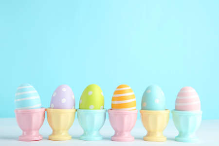 Colorful easter eggs in stands on blue background