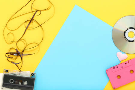 Cassette tapes and cd disk on colorful background