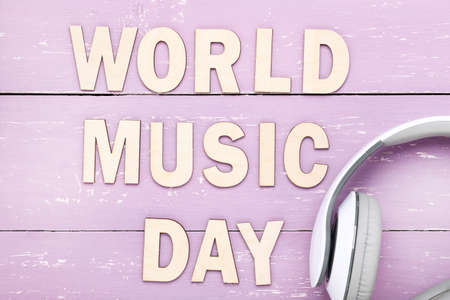Headphones and inscription World Music Day on purple wooden backgroundの写真素材