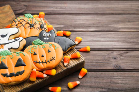 Halloween gingerbread cookies with candies on wooden tableの写真素材