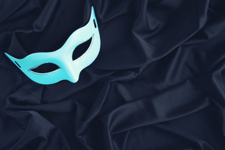 Carnival mask on black fabric backgroundの写真素材