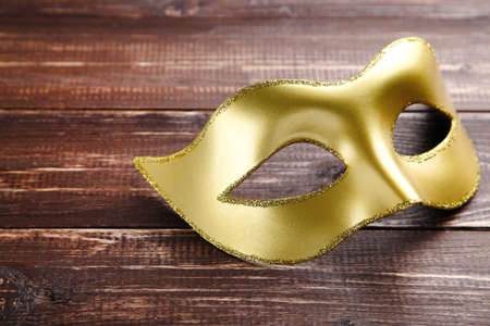 Carnival mask on brown wooden tableの写真素材