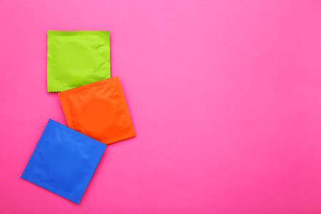 Colorful condoms on pink backgroundの写真素材