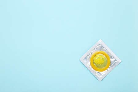 Yellow condom on blue backgroundの写真素材