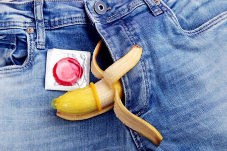 Banana with condom and blue jeansの写真素材