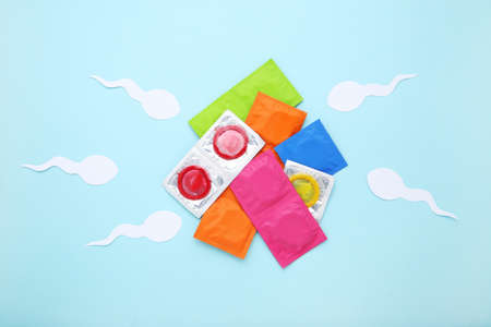 Condom in packs with paper sperms on blue backgroundの写真素材