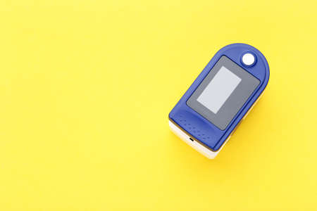 Pulse oximeter on yellow background