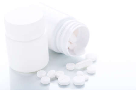 Medicine pills and bottles on white backgroundの写真素材