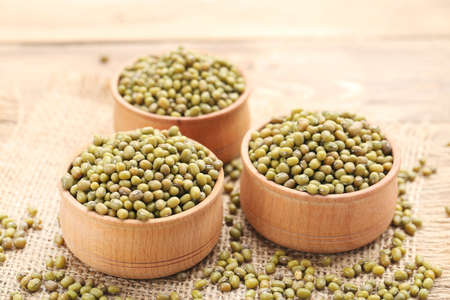 Soy beans with bowls on wooden backgroundの写真素材