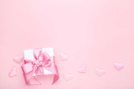 Gift box with hearts on pink backgroundの写真素材