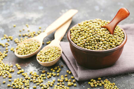 Soy beans with bowl and spoons on gray backgroundの写真素材