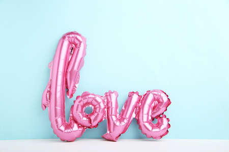 Balloon in shape of word Love on blue backgroundの写真素材