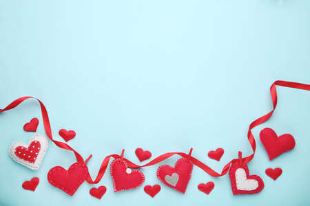 Fabric hearts with ribbon on blue backgroundの写真素材