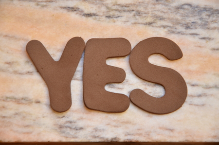 WORD YES on an abstract backgroundの写真素材