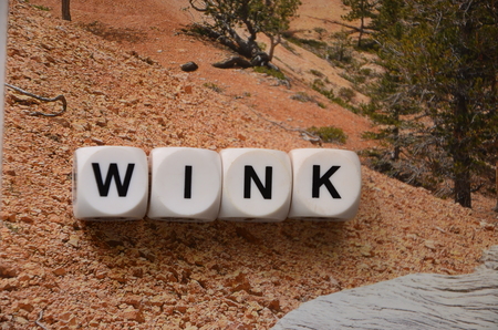 word wink on an abstractly colored backgroundの写真素材