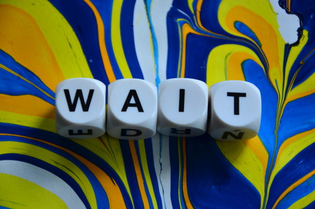 Word wait on an abstract colorful backgroundの写真素材