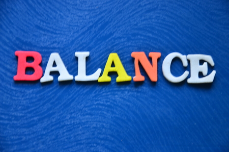 word balance on an abstract blue backgroundの写真素材