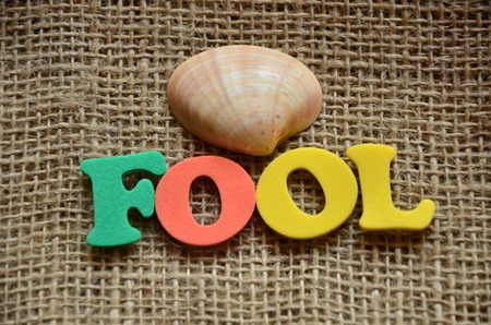 word fool on an abstract backgroundの写真素材