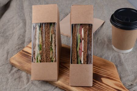 Eco-friendly coffee and sandwiches with fresh vegetables, tuna, salmon and herring paste. Vegan food.の写真素材