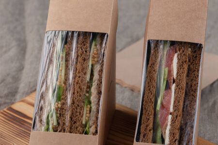 Eco-friendly sandwiches with fresh vegetables, tuna, salmon and herring paste. Vegan food.の写真素材