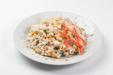Crab sticks salad on white dishの写真素材