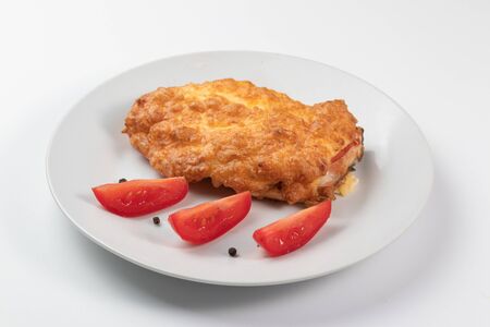 French meat on a white dish with tomatoesの写真素材