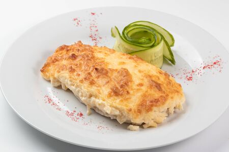 Steak with cheese on a white dishの写真素材