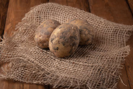 Eco vegetables - white potatoes on a wooden background, vegan foodの写真素材