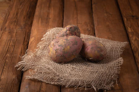 Eco vegetables - red potatoes on a wooden background, vegan foodの写真素材